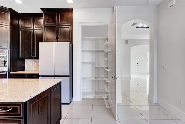 a bathroom with a sink a toilet a mirror and shower