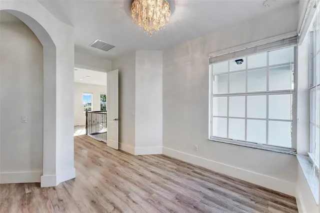 a view of a balcony with wooden floor and fence