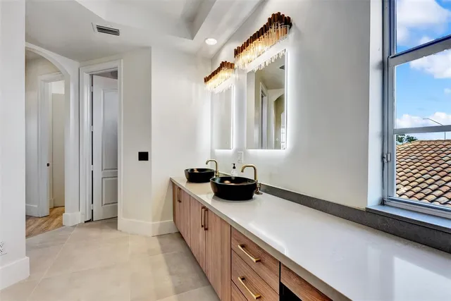 a view of a room with wooden floor and a kitchen