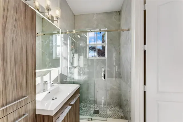 a bathroom with a sink and a large mirror