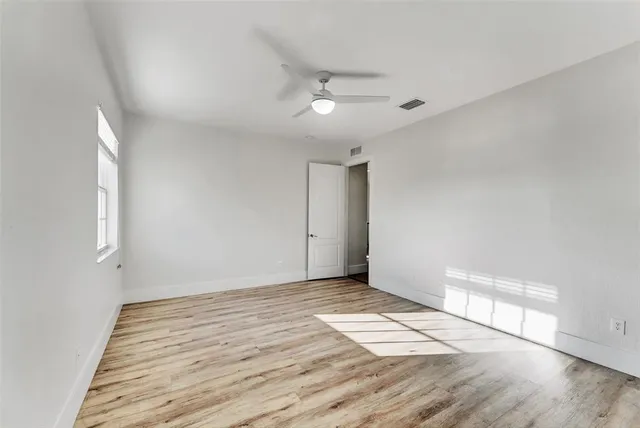 a view of a room with wooden floor and windows