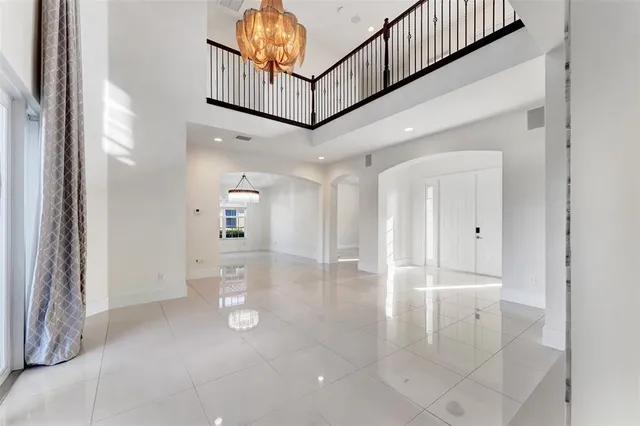 a view of a hallway with wooden floor and entryway