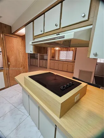 a view of kitchen sink and refrigerator