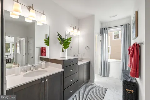a spacious bathroom with a double vanity sink and a mirror