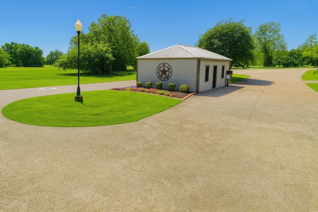 a view of a house with a swimming pool and a yard