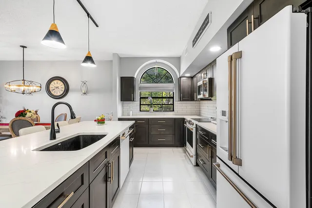a kitchen with a stove a sink and a refrigerator