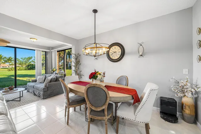 a living room with furniture a clock and a large window