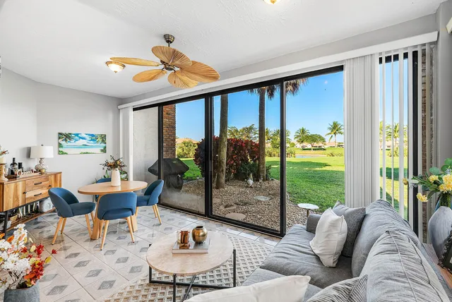 a living room filled with furniture and a large window