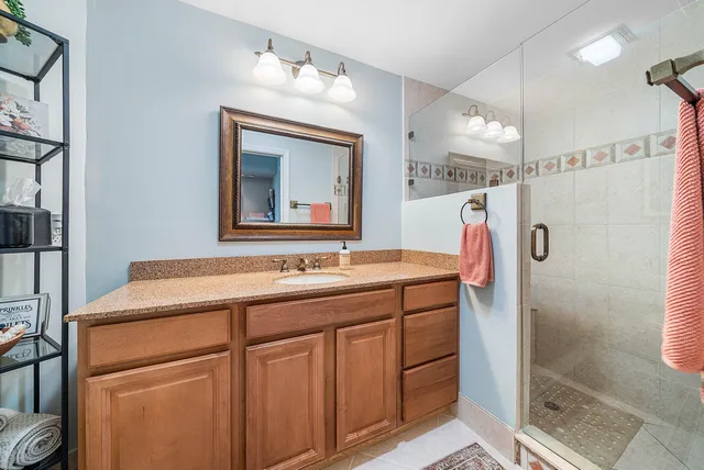 a bathroom with a sink vanity and a mirror