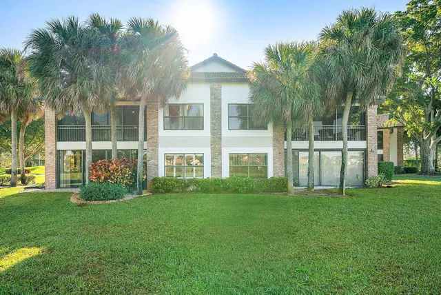 a front view of a house with a garden and plants