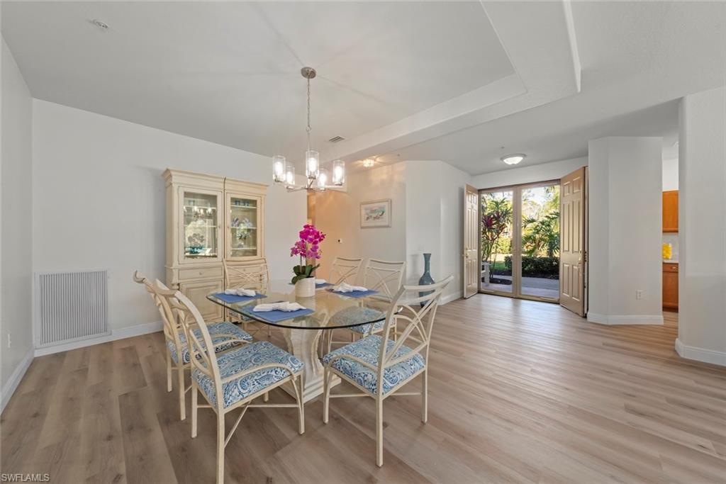 4630 Winged Foot Court, Unit 101 Naples, FL 34112 - Photo 12 of 43 a view of a dining room with furniture window and wooden floor