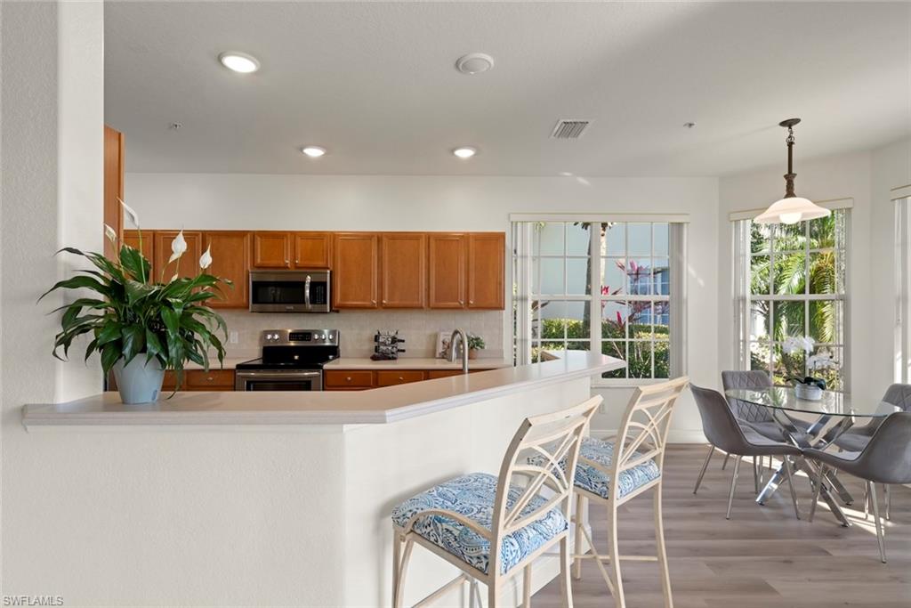 4630 Winged Foot Court, Unit 101 Naples, FL 34112 - Photo 16 of 43 a view of a dining room with furniture window and outside view