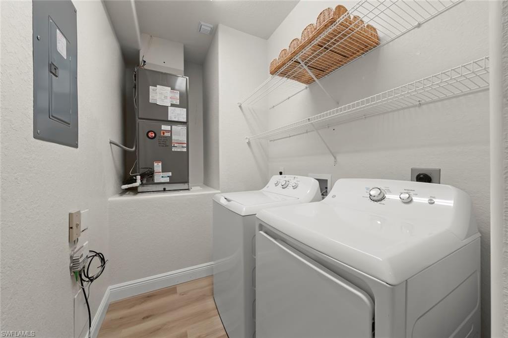 4630 Winged Foot Court, Unit 101 Naples, FL 34112 - Photo 19 of 43 a utility room with dryer and washer