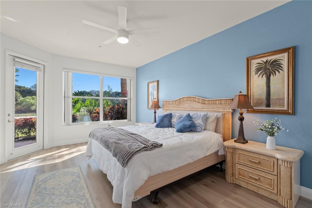 4630 Winged Foot Court, Unit 101 Naples, FL 34112 - Photo 2 of 43 a bedroom with a large bed and a window