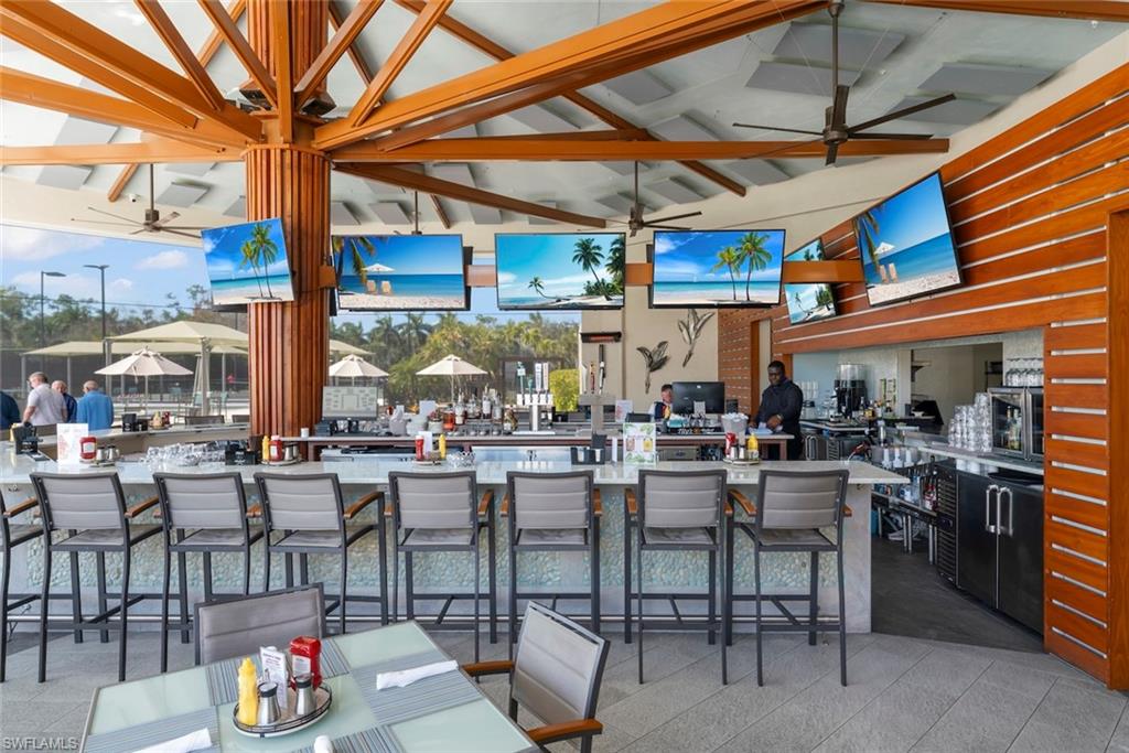 4630 Winged Foot Court, Unit 101 Naples, FL 34112 - Photo 33 of 43 a view of a patio with dining table and chairs