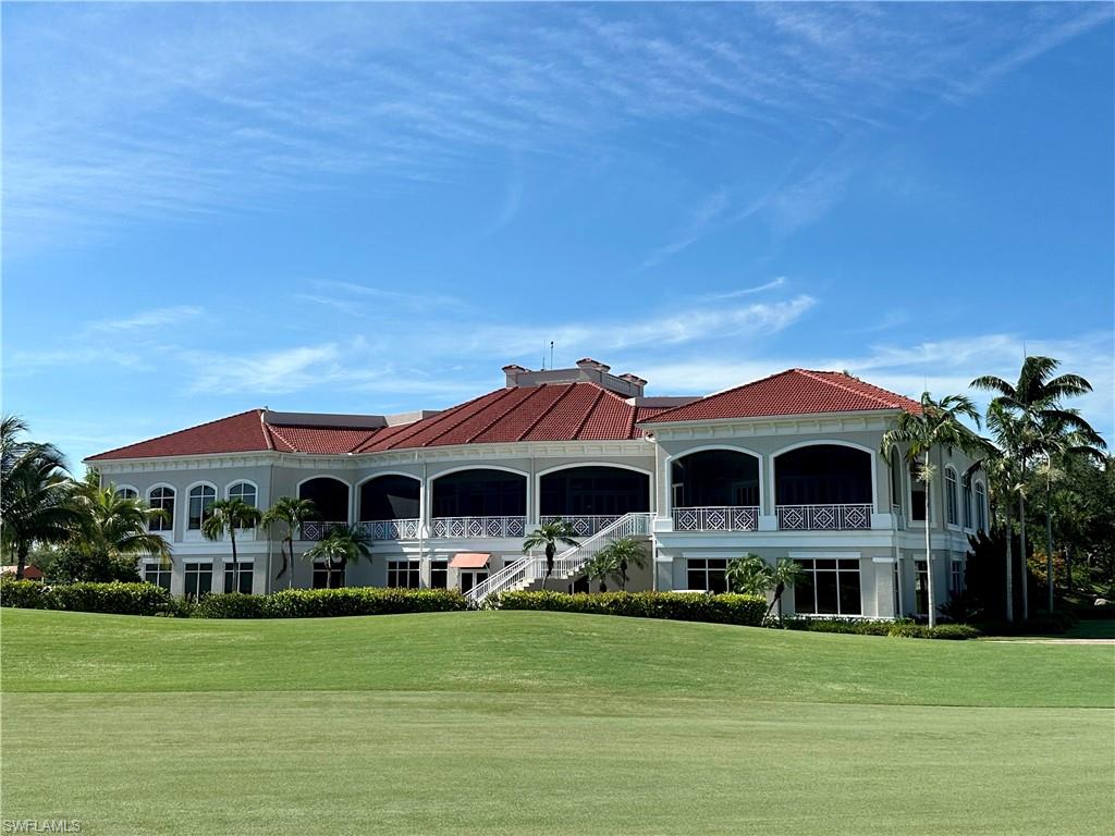 4630 Winged Foot Court, Unit 101 Naples, FL 34112 - Photo 39 of 43 a front view of a house with a garden