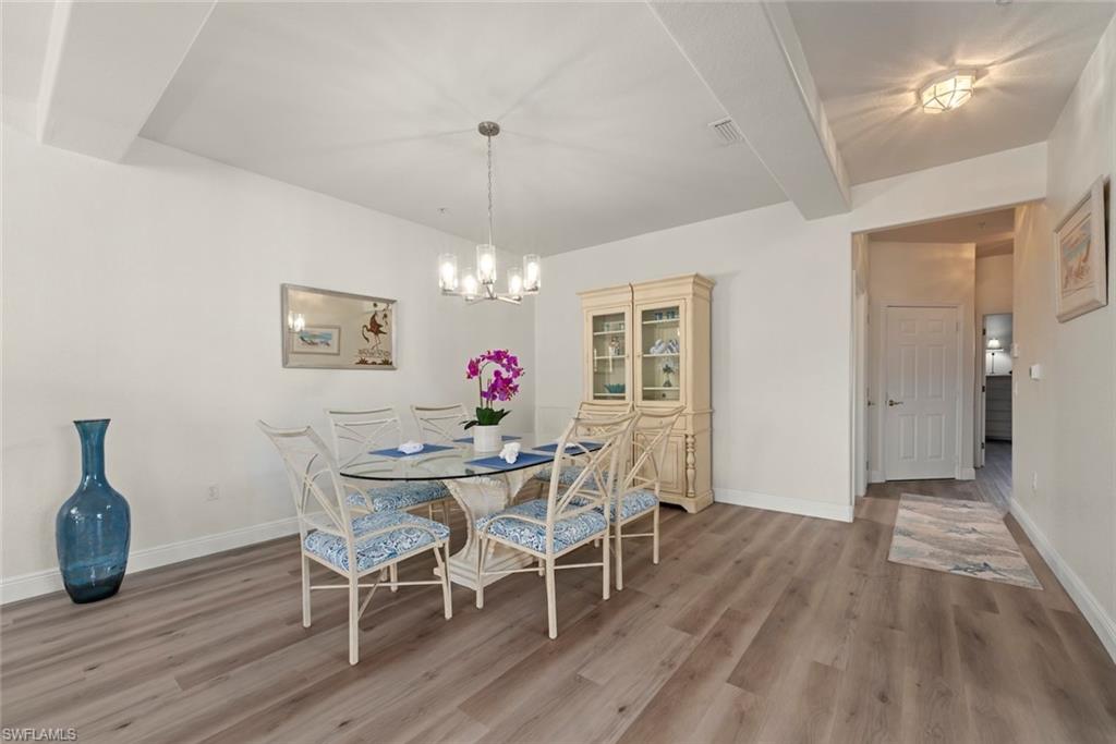 4630 Winged Foot Court, Unit 101 Naples, FL 34112 - Photo 4 of 43 a view of a dining room with furniture and chandelier