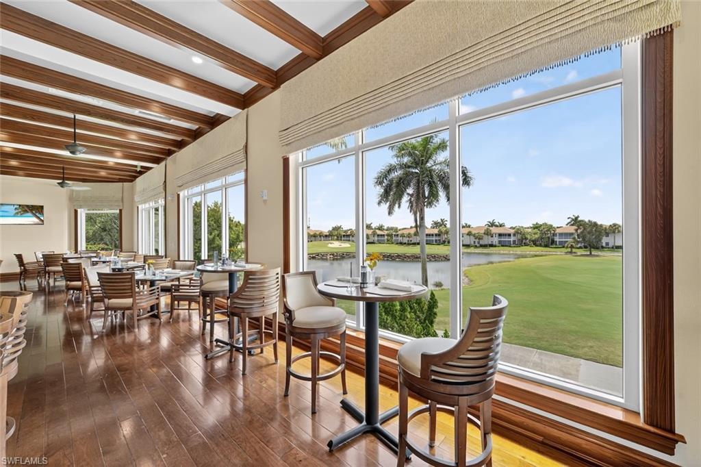 4630 Winged Foot Court, Unit 101 Naples, FL 34112 - Photo 41 of 43 a living room with patio furniture and floor to ceiling windows
