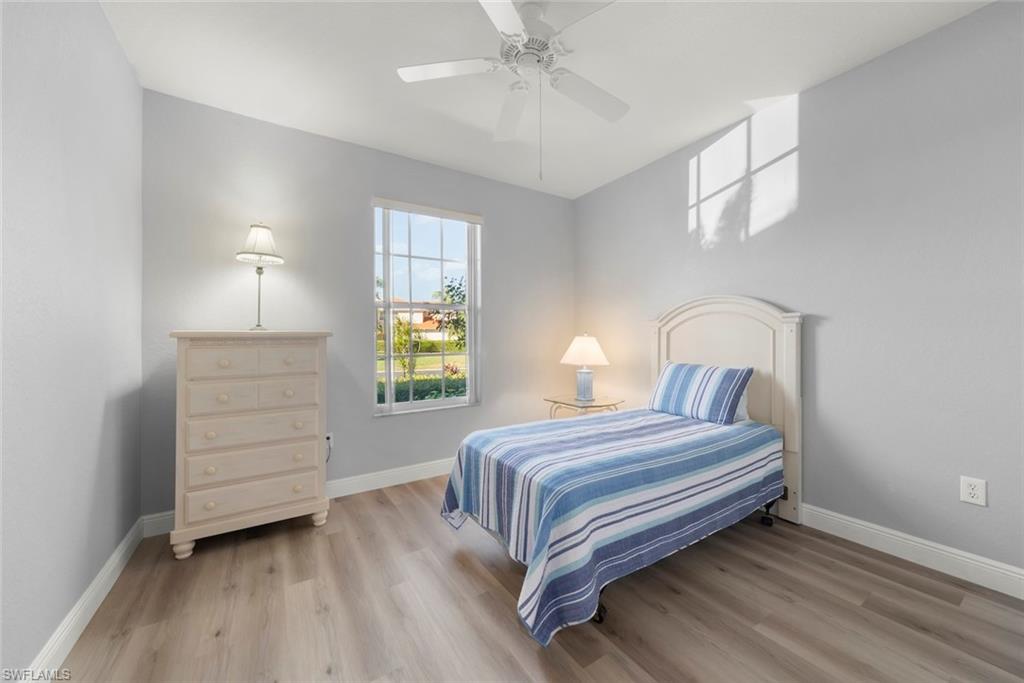 4630 Winged Foot Court, Unit 101 Naples, FL 34112 - Photo 9 of 43 a bedroom with a bed and a closet