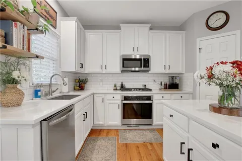a kitchen with appliances cabinets and a sink