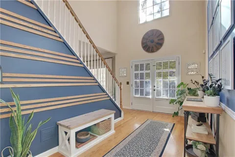 a view of an entryway with wooden floor
