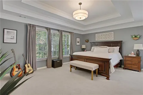 a bedroom with a bed and a chandelier