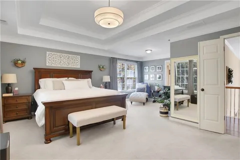 a bedroom with furniture and a large window