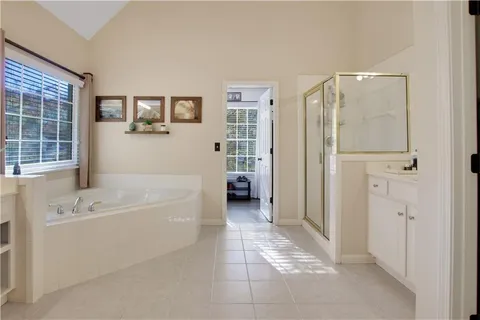 a bathroom with a bathtub shower and a sink