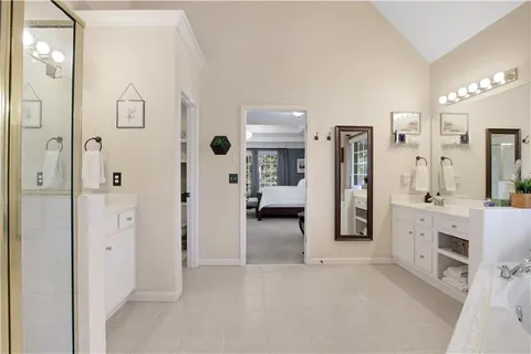 a bathroom with a tub sink shower and mirror