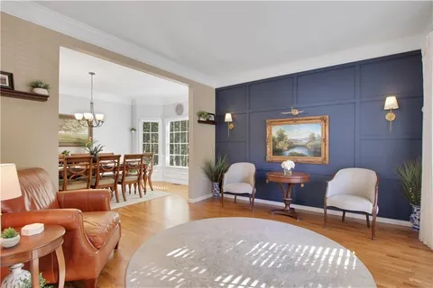 a living room with furniture a rug and a large window