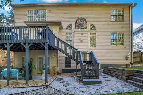 an aerial view of a house having swimming pool patio and a yard