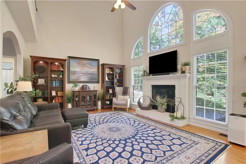 a living room with furniture a flat screen tv and a fireplace