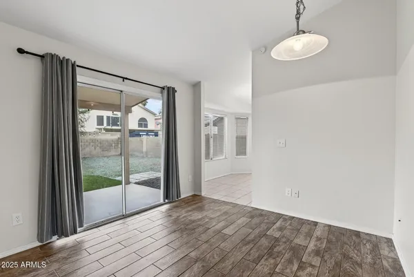 a view of a room with wooden floor and window