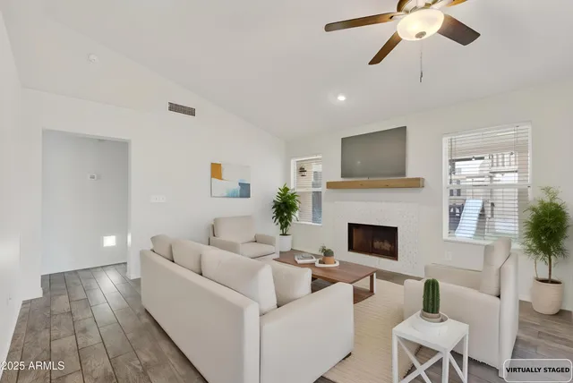 a living room with furniture and a fireplace