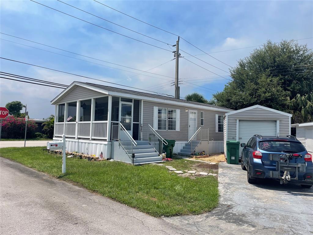 8581 Southwest 16th Street Davie, FL 33324 - Photo 2 of 12 a front view of a house with a garden and porch