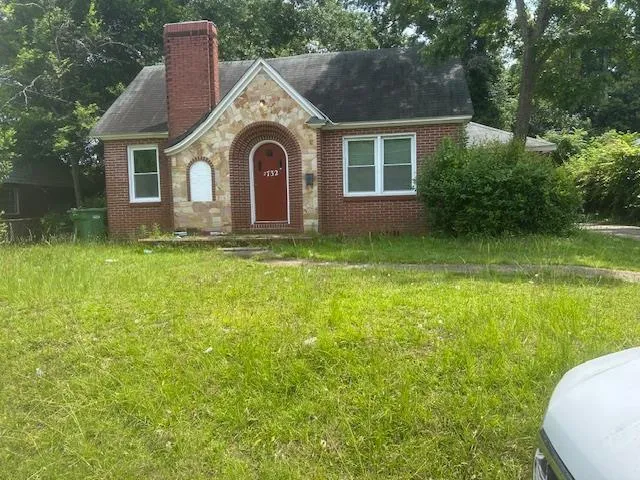 a front view of a house with garden