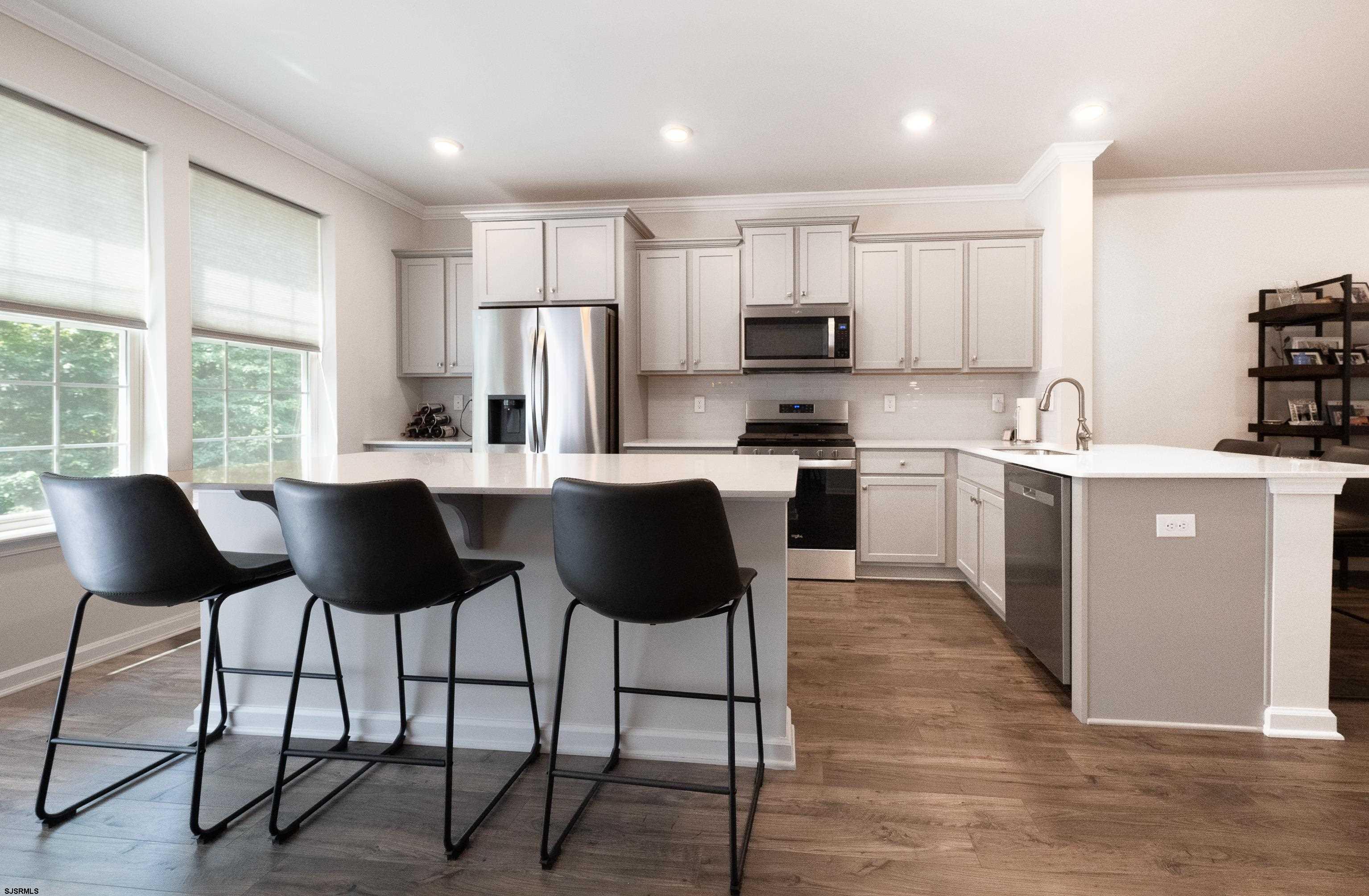 18 Lilac Circle Mount Laurel, NJ 08054 - Photo 17 of 52 a kitchen with stainless steel appliances granite countertop a stove a sink a microwave a dining table and chairs