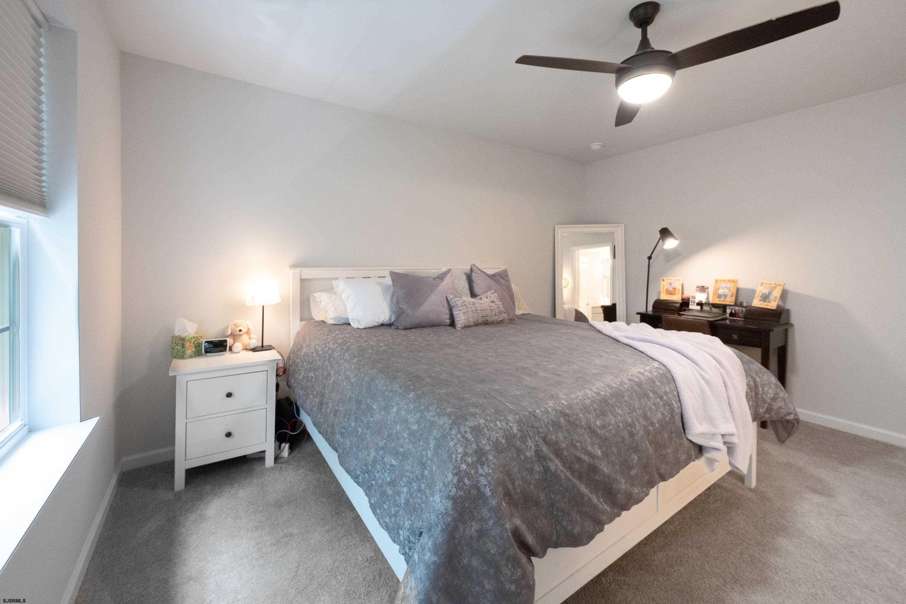 18 Lilac Circle Mount Laurel, NJ 08054 - Photo 30 of 52 a spacious bedroom with a bed and a chandelier