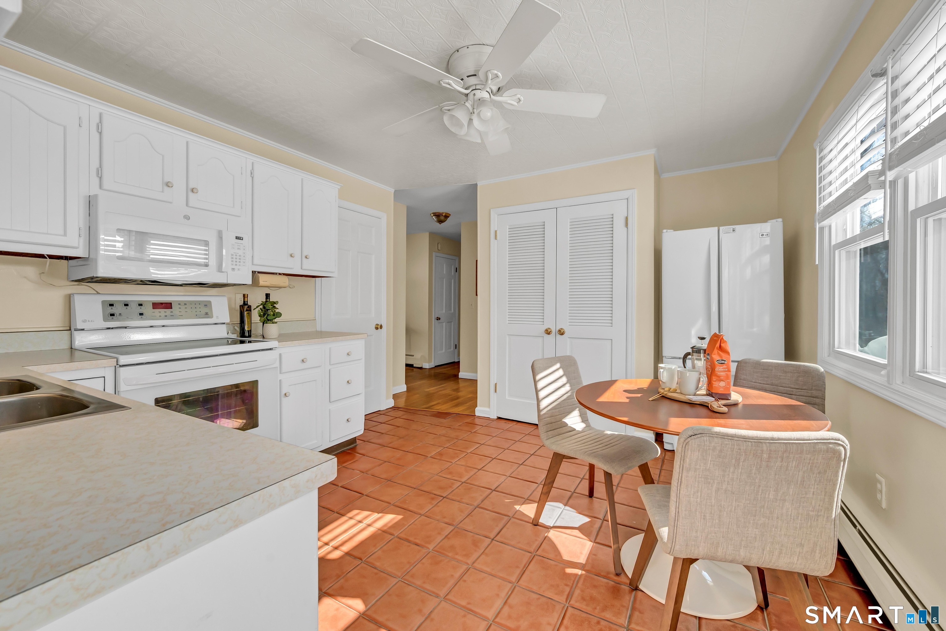 40 Middle River Road Danbury, CT 06811 - Photo 19 of 40 a living room with stainless steel appliances kitchen island granite countertop a dining table chairs and a refrigerator