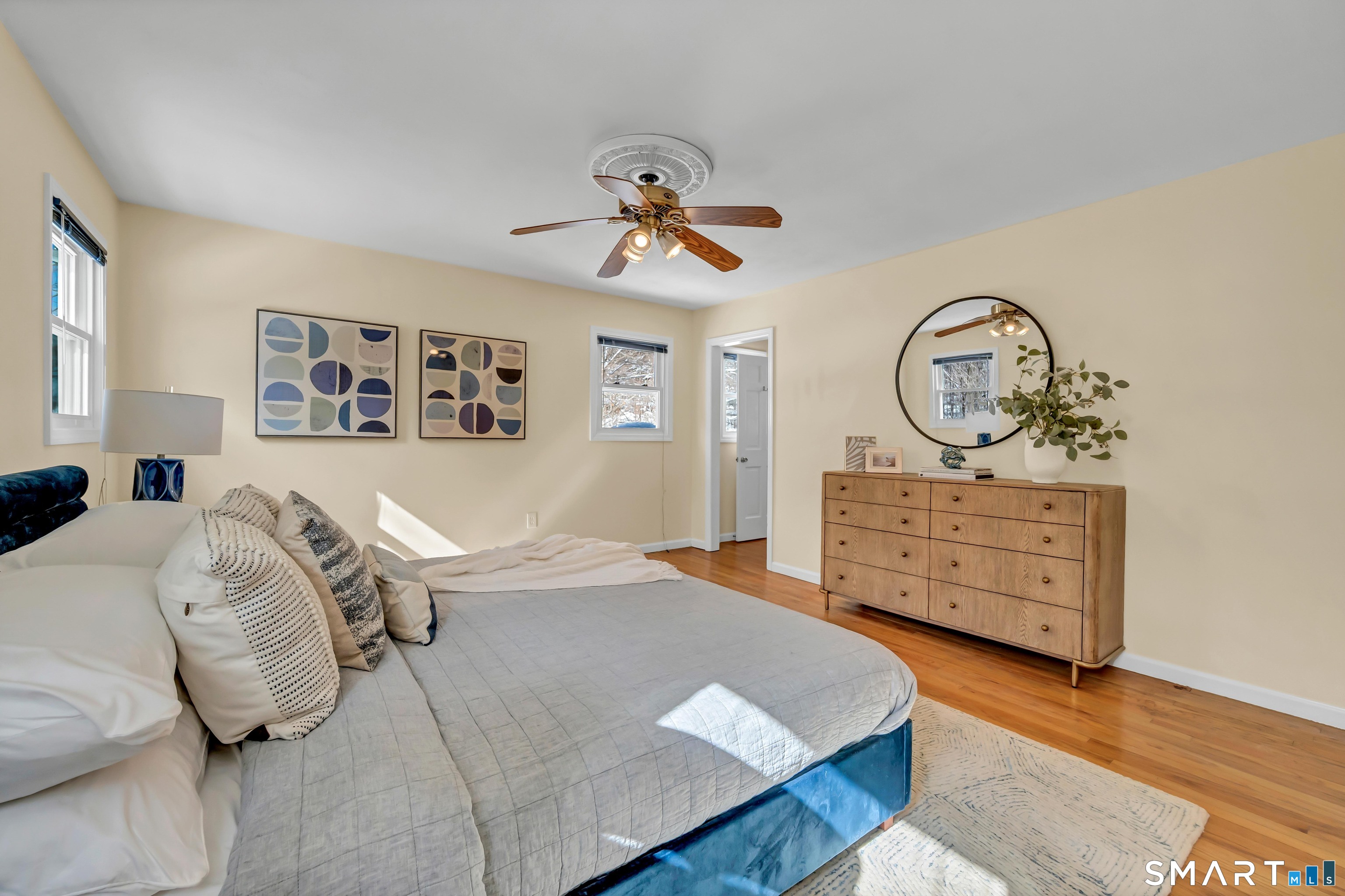40 Middle River Road Danbury, CT 06811 - Photo 5 of 40 a bedroom with a bed a dresser and painting on the wall