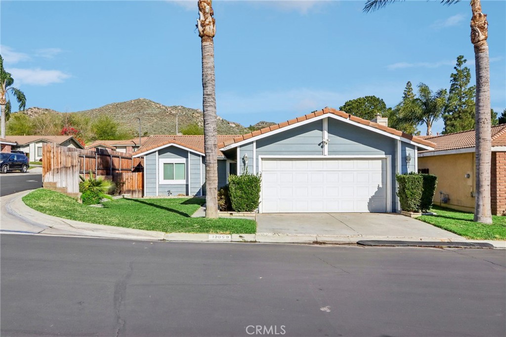 12059 Elk Boulevard Riverside, CA 92505 - Photo 1 of 29 a view of a house with a yard and garage