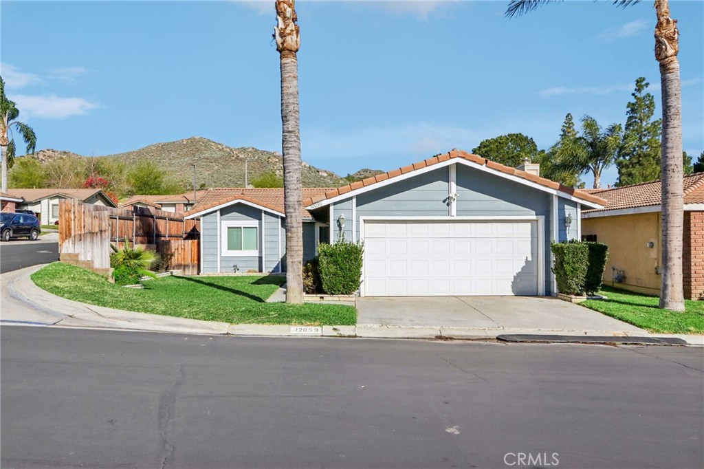 12059 Elk Boulevard Riverside, CA 92505 - Photo 1 of 1 a view of a house with a yard and garage