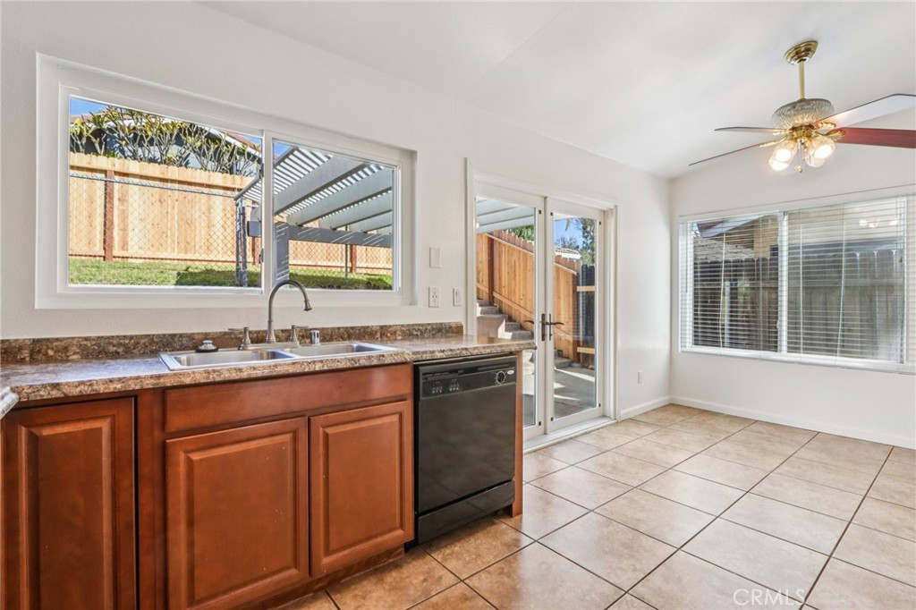 12059 Elk Boulevard Riverside, CA 92505 - Photo 12 of 29 a kitchen with a sink window and cabinets