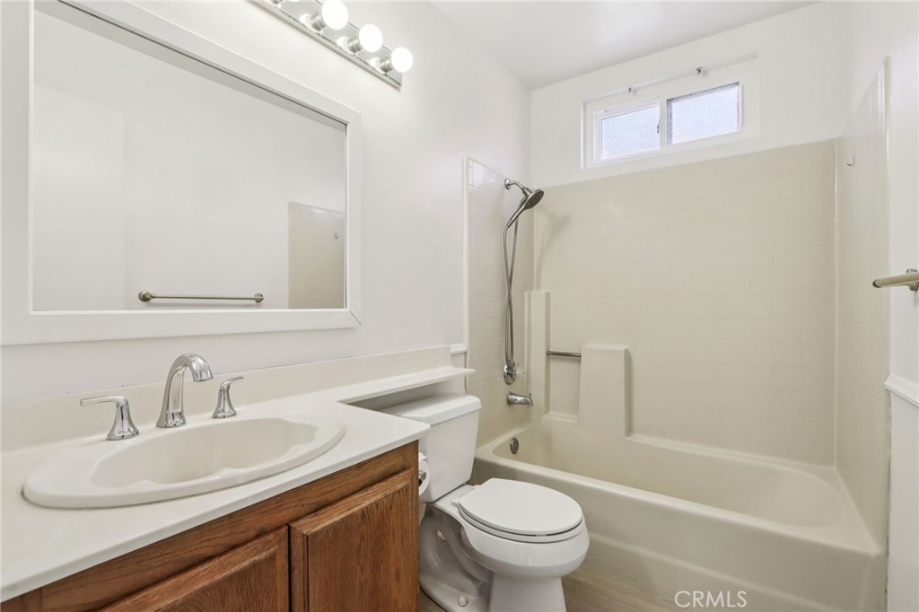 12059 Elk Boulevard Riverside, CA 92505 - Photo 18 of 29 a bathroom with a sink toilet and shower