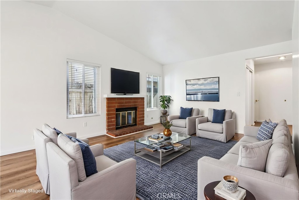 12059 Elk Boulevard Riverside, CA 92505 - Photo 4 of 29 a living room with furniture a fireplace and a flat screen tv