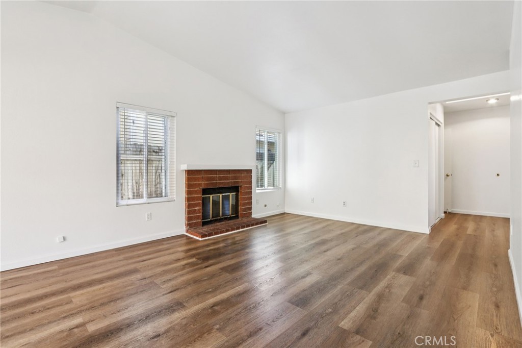 12059 Elk Boulevard Riverside, CA 92505 - Photo 5 of 29 a view of empty room with wooden floor and fireplace