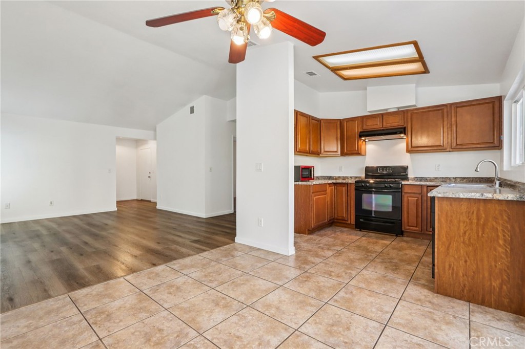 12059 Elk Boulevard Riverside, CA 92505 - Photo 9 of 29 a kitchen with stainless steel appliances granite countertop a refrigerator and a sink