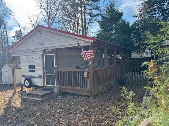 a view of a house with a yard and fence
