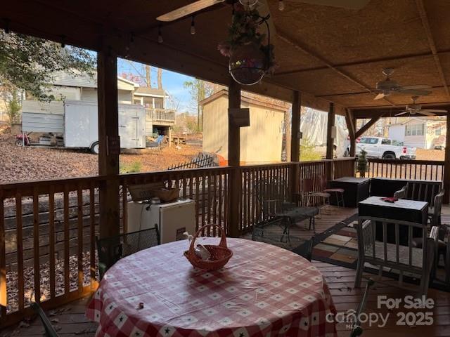 127 Deer Park Road Mount Gilead, NC 27306 - Photo 14 of 15 a table and chairs with wooden floor in front of a yard