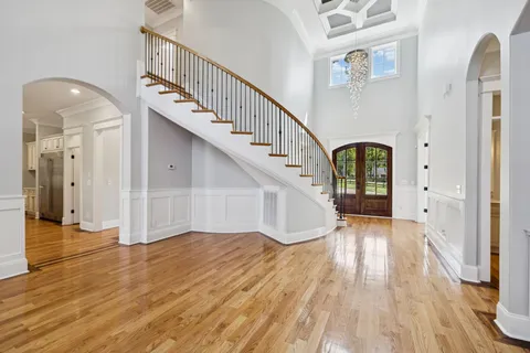 a large kitchen with kitchen island a counter space a sink stainless steel appliances and cabinets